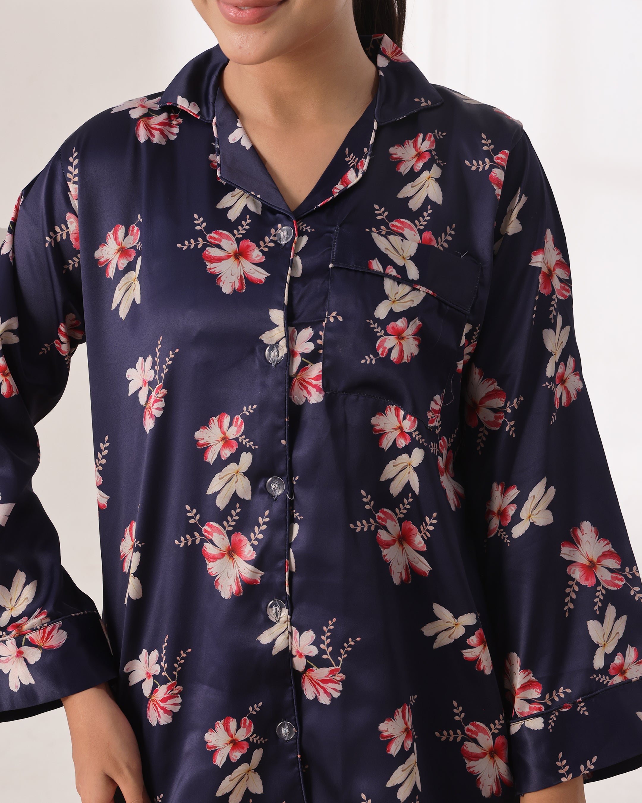Navy satin pajama top with floral pattern on a white background