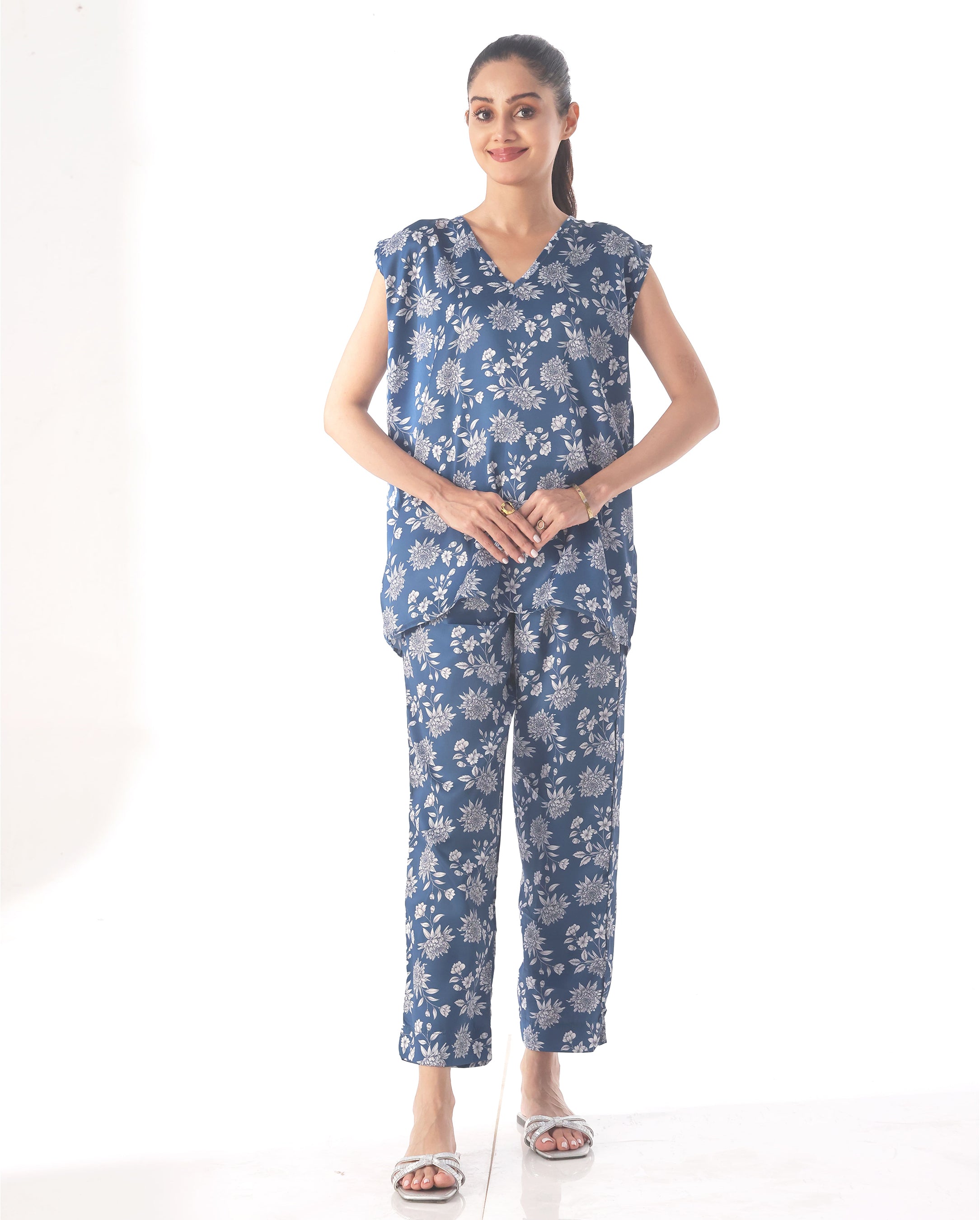 Woman wearing a blue floral outfit on a white background
