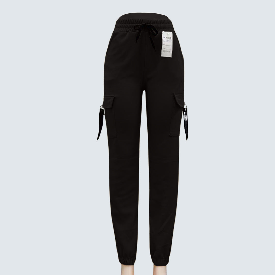 A pair of brown Sajiero trousers made of polyester and spandex, displayed flat on a surface.