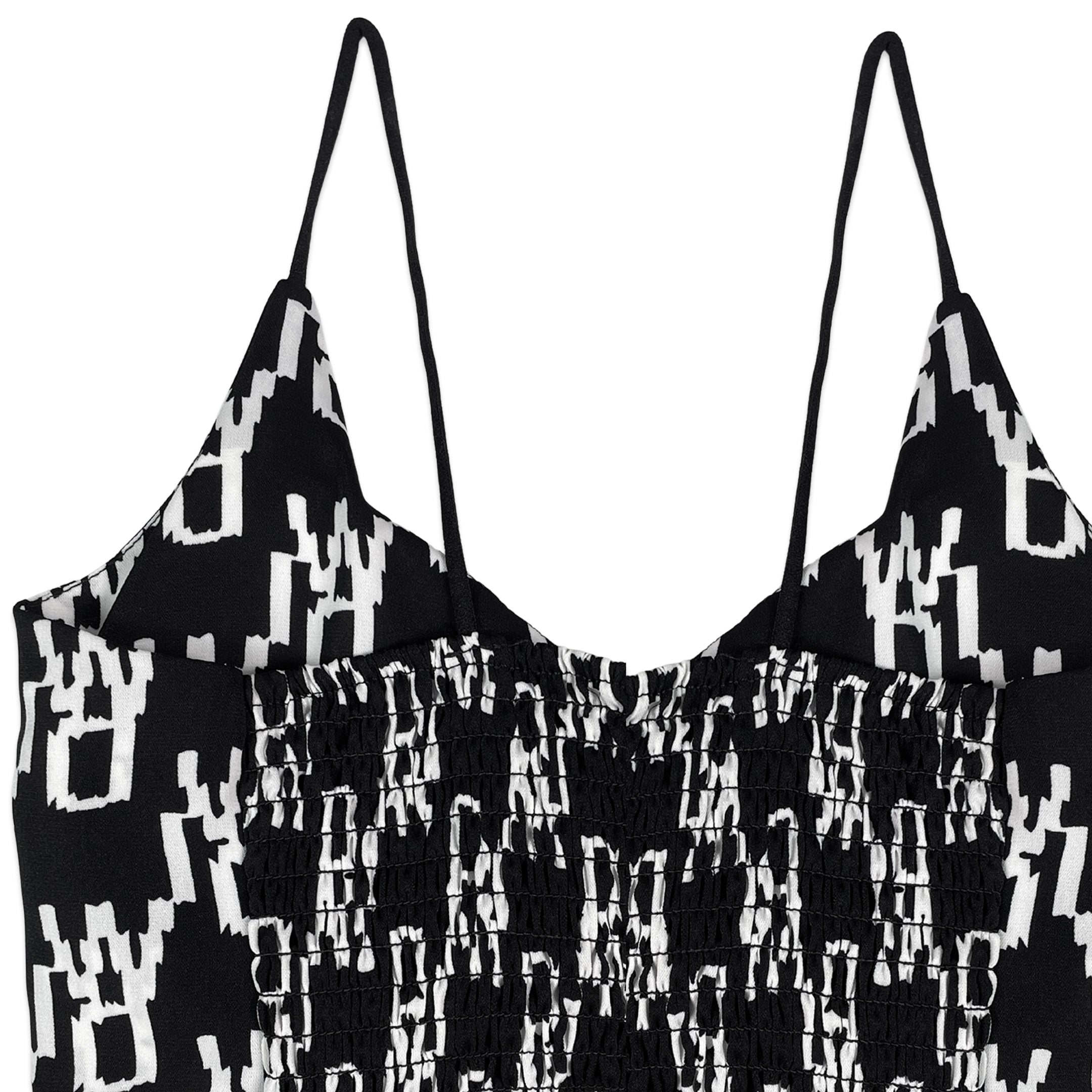 Black and white patterned top with thin straps on a white background