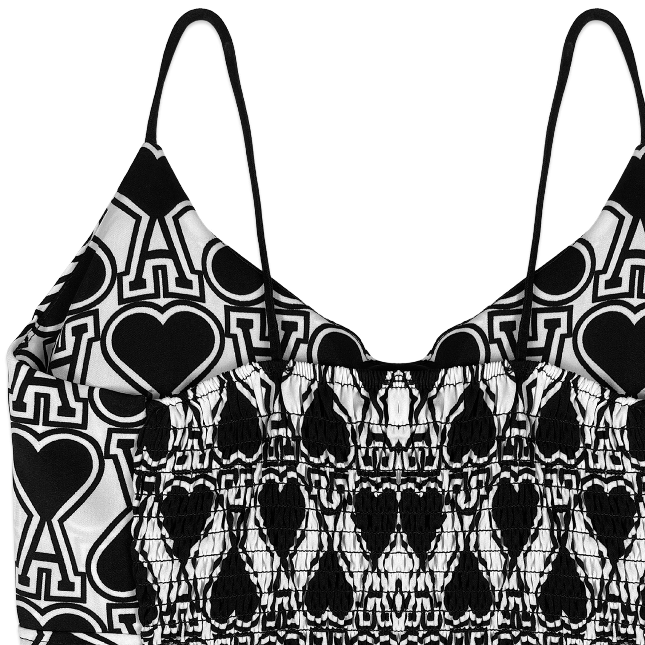 Black and white patterned top with heart designs on a white background