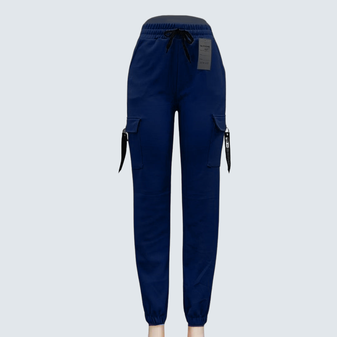 A pair of brown Sajiero trousers made of polyester and spandex, displayed flat on a surface.